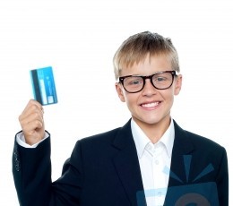 young-boy-holding-credit-card-100108537